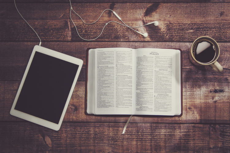 e-reader, Bible, and coffee mug